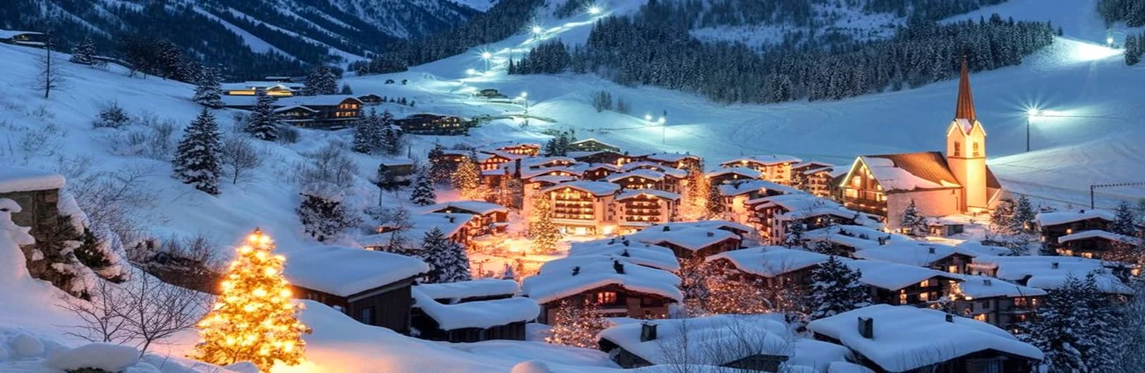 Ischgl Austria ski resort 2025 - Silvretta Arena slopes with modern cable cars, alpine mountains, duty-free shopping village and famous après-ski bars