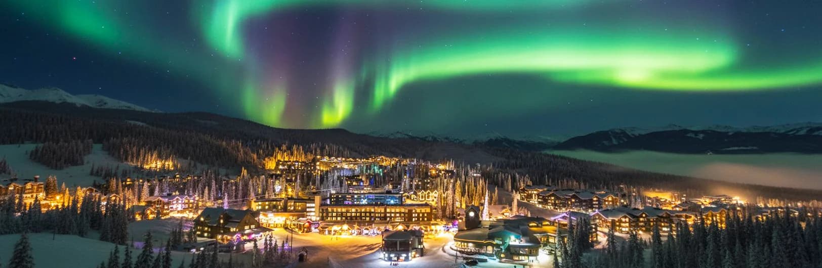 Big White Ski Resort family-friendly winter wonderland featuring unique snow ghosts heavily-frosted trees creating magical landscape, Canada's largest ski-in ski-out pedestrian village with accommodations at lift base, gentle beginner slopes perfect for children learning to ski, Okanagan champagne powder covering 119 runs, Happy Valley tube park, and families skiing together - British Columbia's premier family ski destination 2,765 acres 2025