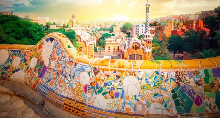 Colorful mosaic tiles at Park Güell Barcelona with Gaudí architecture, Mediterranean cityscape and artistic ceramic bench design