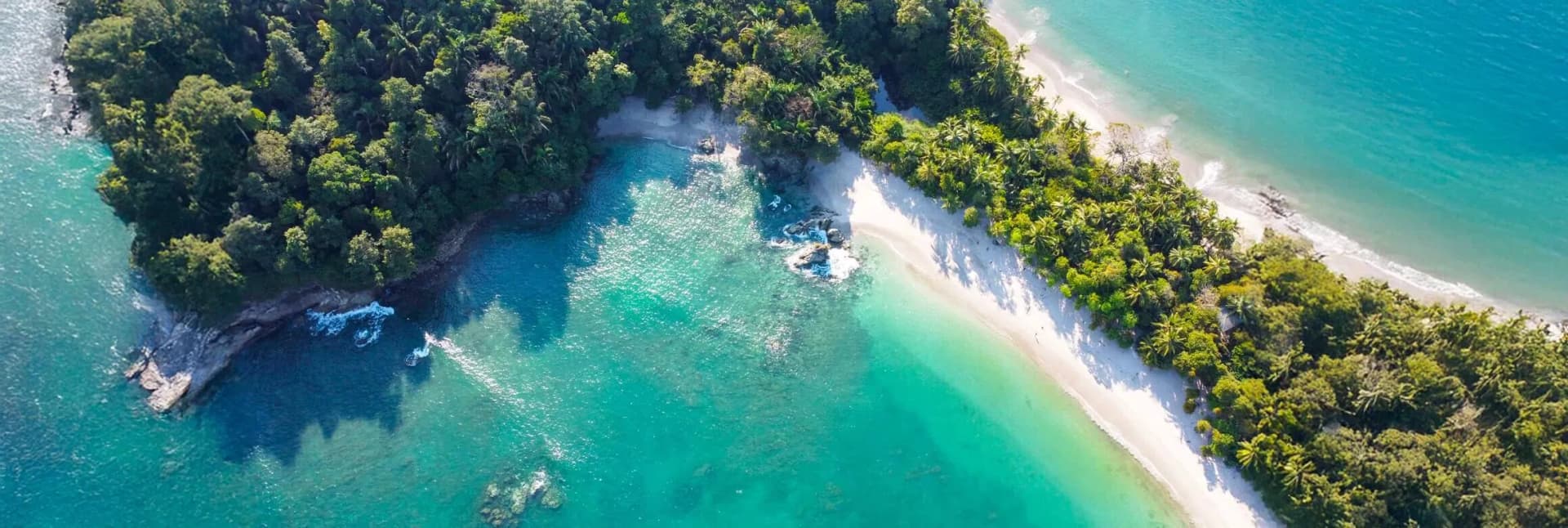 Costa Rica in December 2025 featuring Arenal Volcano cone rising above lush tropical rainforest with natural hot springs, misty cloud forest canopy, white-sand beaches of Manuel Antonio National Park, and vibrant biodiversity including sloths and toucans, showcasing perfect dry season weather for eco-adventures, zip-lining, and wildlife viewing in Central America's pura vida paradise