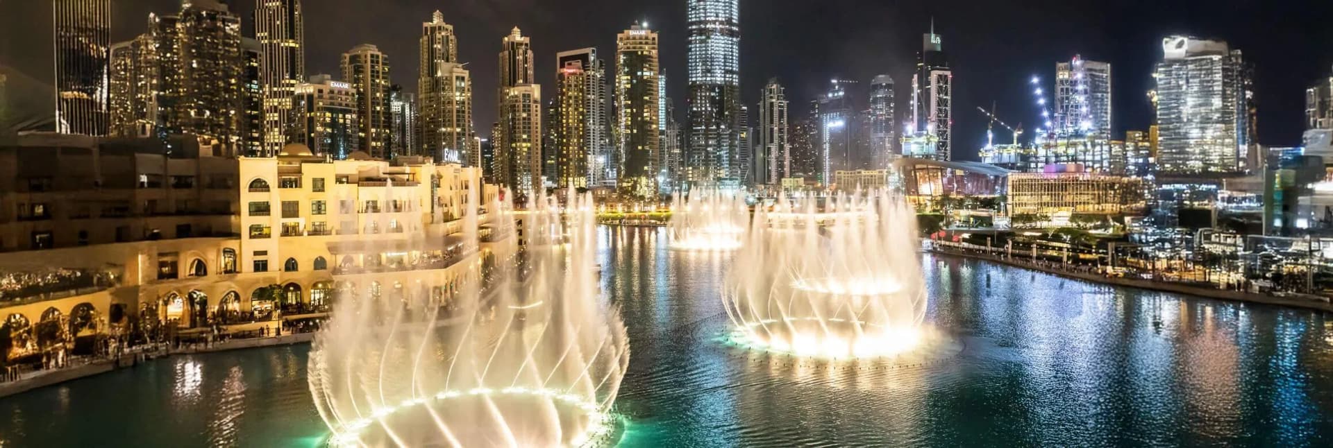 Dubai UAE in December 2025 featuring Burj Khalifa tallest building with illuminated fountain show, luxury Dubai Marina skyline at sunset, traditional gold souk markets with jewelry displays, desert safari with 4x4 dune bashing adventure, and Palm Jumeirah beach clubs showcasing peak season weather perfection