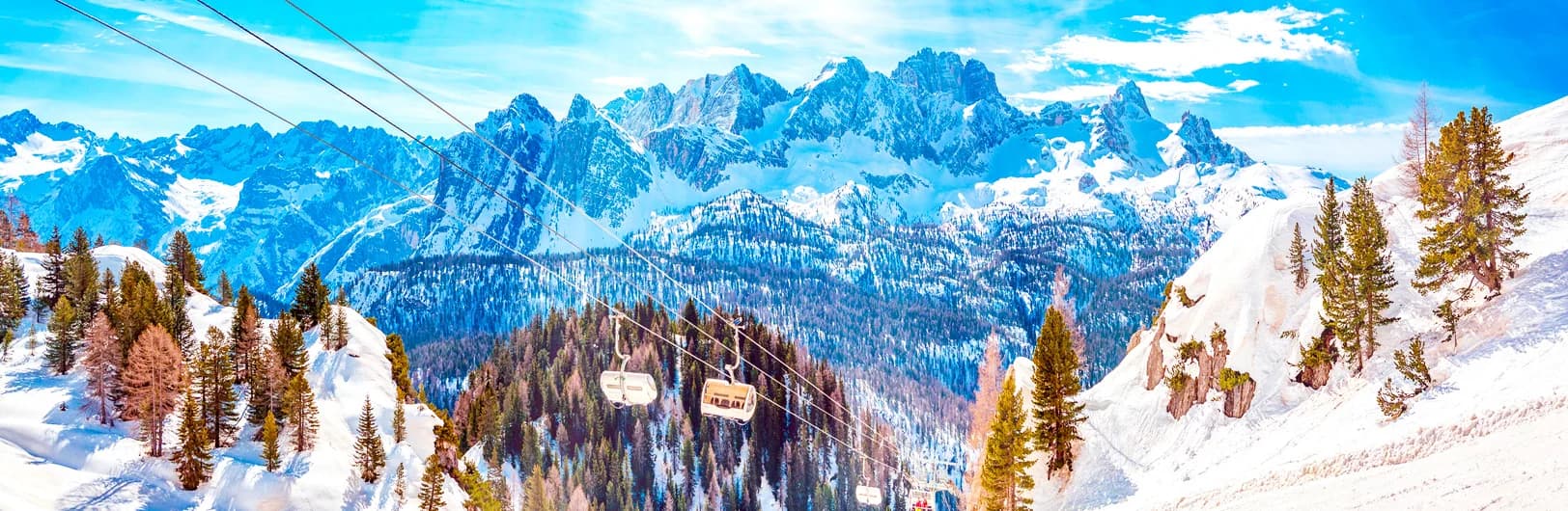 Cortina d'Ampezzo Italy ski resort 2025/26 - glamorous Italian alpine town surrounded by dramatic UNESCO Dolomites limestone peaks with pink alpenglow, 2026 Winter Olympics downhill course visible on Tofane mountains, luxury hotels and boutiques along Corso Italia, skiers on 1,200km Dolomiti Superski slopes