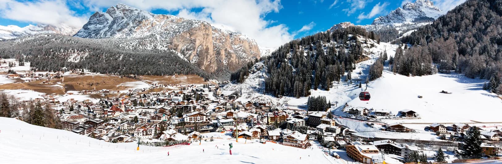 Val Gardena Selva ski resort in South Tyrol Dolomites with iconic Sassolungo peaks, Sella Ronda circuit access, and traditional Ladin Alpine village with modern ski lifts