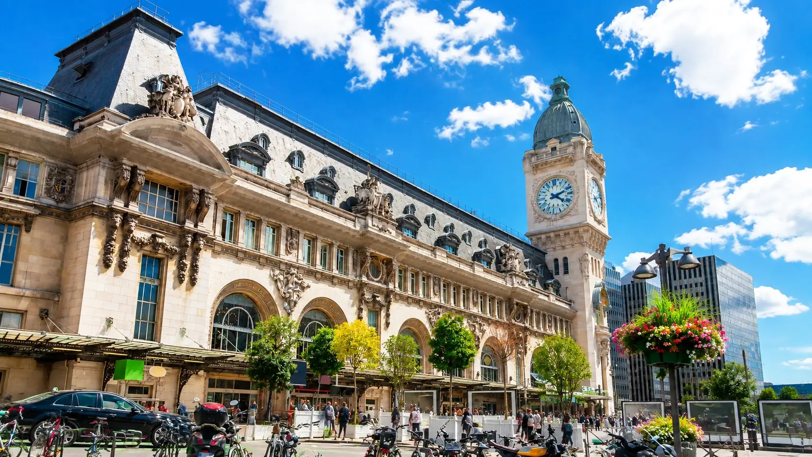 Luxembourg Gare Station District featuring the grand central train station facade, bustling Avenue de la Gare lined with budget-friendly hotels from €64 per night, and the free tram stop connecting travelers to the historic city center in 8 minutes