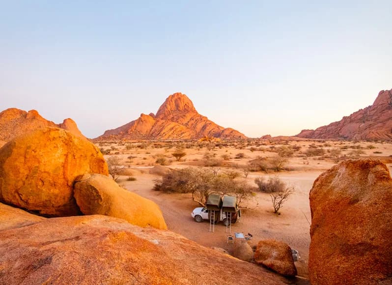 Namibia in November 2025 - dramatic Sossusvlei orange-red sand dunes with ancient dead trees in Deadvlei, Etosha National Park elephants at waterholes, Skeleton Coast shipwrecks on Atlantic shore, starry desert night skies during pre-rain photography perfect conditions