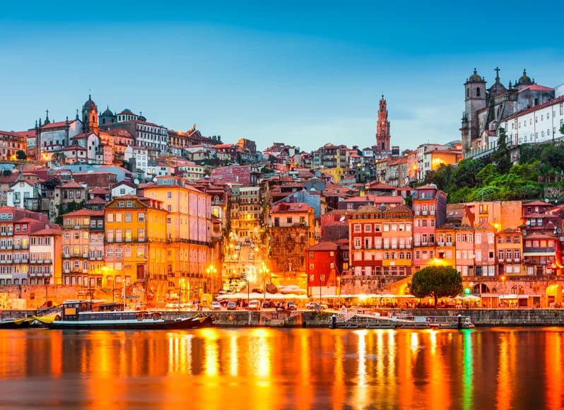 Portugal in November 2025 - golden Porto cityscape illuminated at twilight along Douro River, historic Alfama district with vintage tram 28, colorful Lisbon buildings reflecting on water, Sintra palaces and autumn vineyards during mild Mediterranean shoulder season