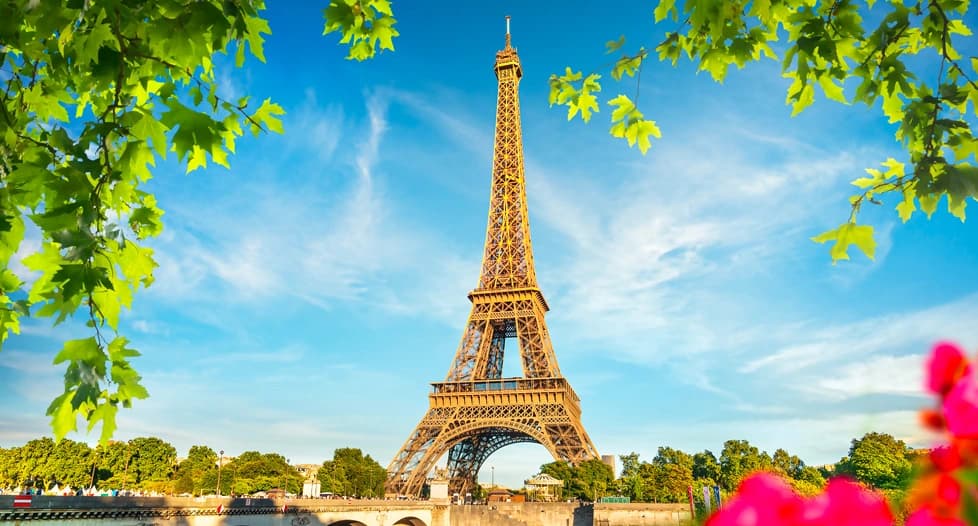 Romantic Paris cityscape with Eiffel Tower, Seine River, Haussmanian architecture and charming cobblestone streets at golden hour