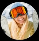 Sophie Bergmann - Austrian ski expert and winter sports journalist specializing in Alpine ski resorts, photographed outdoors wearing adventure gear with mountain scenery in background