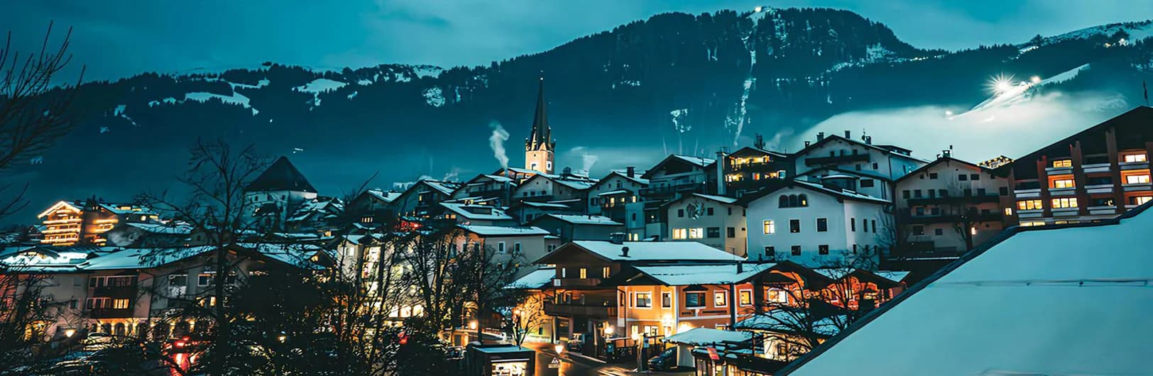 Kitzbühel Austria luxury ski resort 2026 - famous Hahnenkamm downhill race course, 5-star hotels, medieval town with colorful buildings and snow-covered Tyrolean Alps
