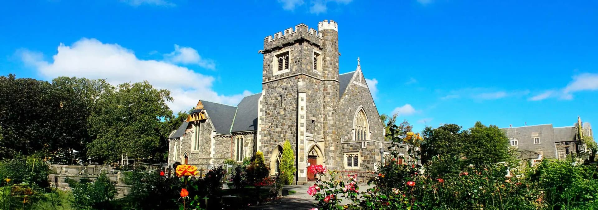 Riccarton neighborhood Christchurch - historic St Peters Anglican Church with Gothic Revival architecture, Riccarton Bush native forest reserve, Westfield Shopping Centre mall, University of Canterbury campus, and Riccarton Road commercial district with Asian restaurants and student cafes