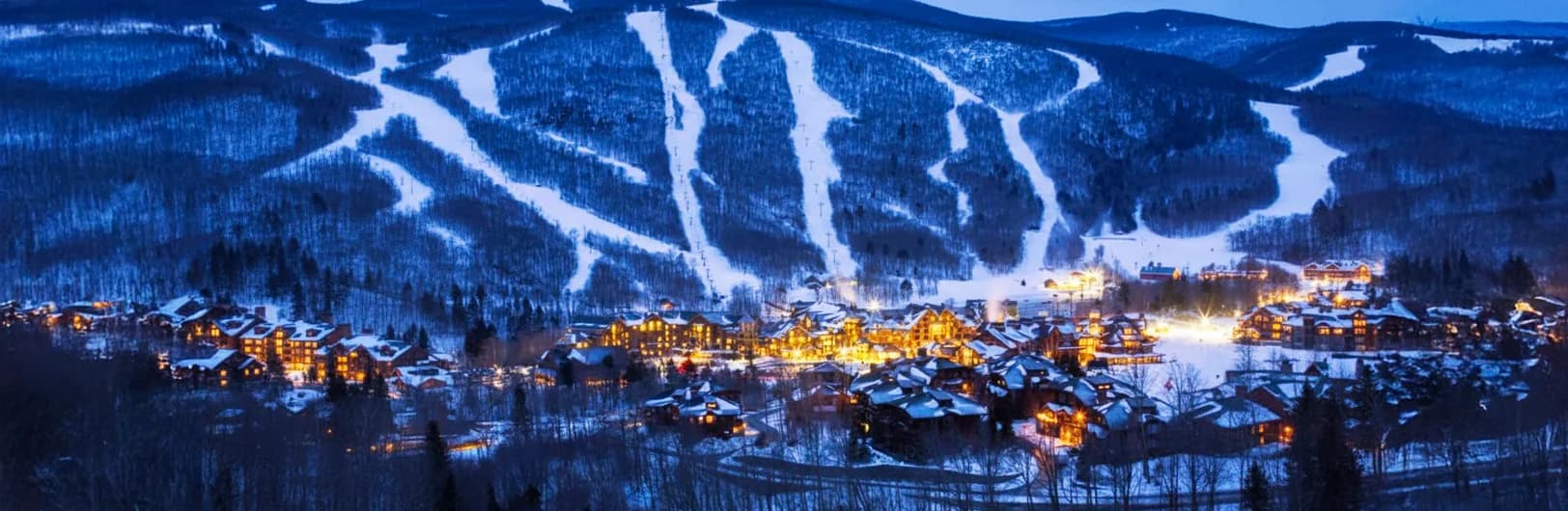 Stowe Mountain Resort Vermont 2026/27 season - Epic Pass destination with 116 trails on Mount Mansfield, classic New England ski village featuring white church steeple and covered bridges, premium East Coast skiing with Front Four expert runs and Spruce Peak family terrain, authentic Vermont winter landscape