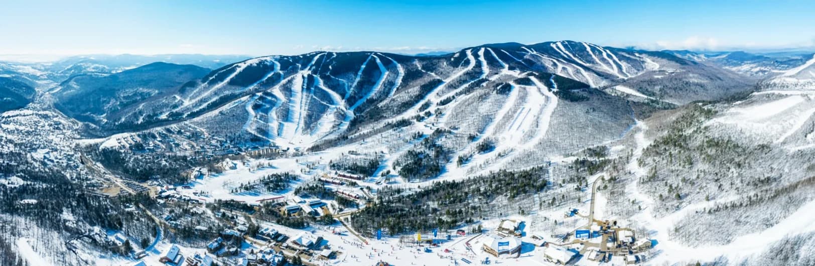 Sunday River Maine 2025/26 Mountain Collective Pass resort - eight interconnected peaks with 870 acres and 135 trails, largest New England ski resort by acreage, White Heat trail longest steepest run in East, White Cap basin with ski-in/ski-out Grand Summit Hotel, twilight skiing Fridays and weekends