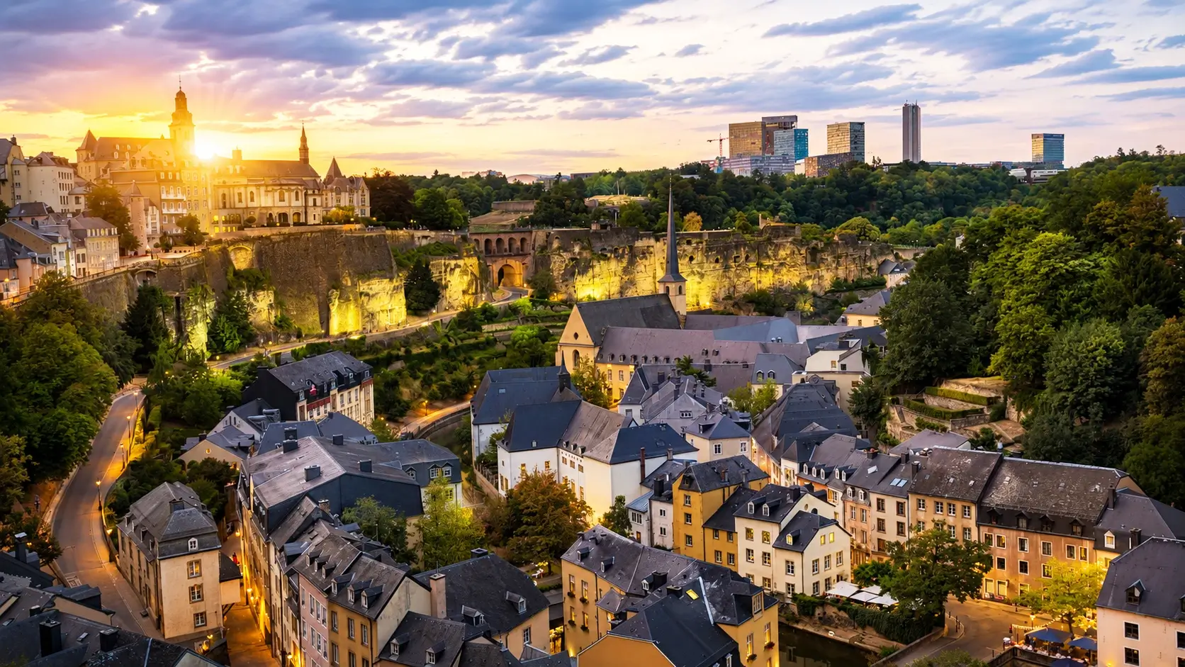 Kirchberg European Quarter in Luxembourg City showcasing striking modern architecture including the glass-fronted Philharmonie concert hall, MUDAM contemporary art museum designed by I.M. Pei, EU institution buildings, and upscale business hotels from €108 per night