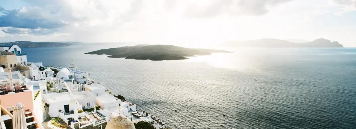 Fira Santorini 2026 - bustling island capital with white-washed buildings on the caldera cliff, narrow shopping streets, restaurants and bars with sunset views, cable car to old port, and vibrant nightlife scene