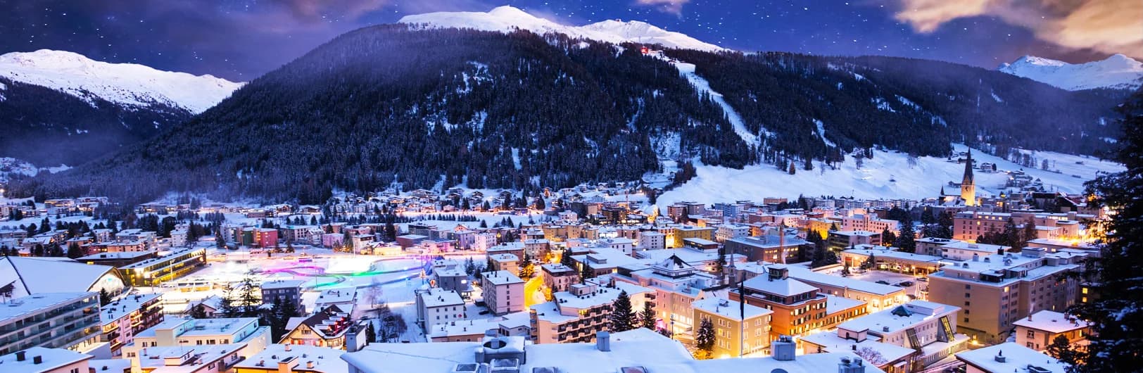 Davos Klosters ski resort Switzerland largest ski region - Parsenn mountain with 300km of terrain, Jakobshorn freeride slopes, traditional Swiss alpine village of Klosters, wide groomed runs for intermediate skiers, snow-covered peaks, World Economic Forum location winter 2026