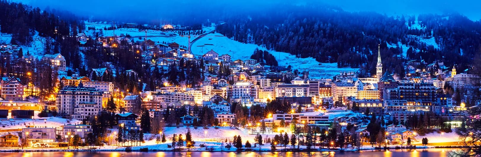 St Moritz luxury ski resort Switzerland - iconic 5-star palace hotels including Badrutts Palace along frozen lake, Corviglia and Corvatsch ski slopes with 350km terrain, designer boutiques on Via Serlas, champagne climate with 300 sunny days, Engadin valley alpine scenery winter 2026